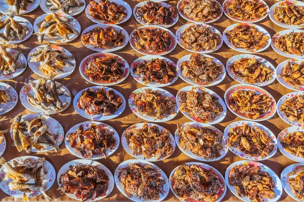 Many kinds of deep fried fish on dish for sale at street food in Thailand.