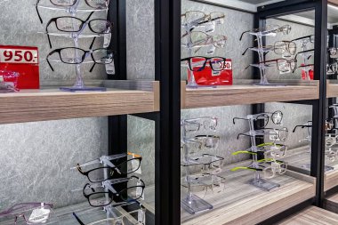 KANCHANABURI, THAILAND-OCTOBER 12, 2024 : Inside the sleek, modern optical shop offers professional eye exams and wide selection of beautiful, fashion glasses on shelves at Top Charoen Optical