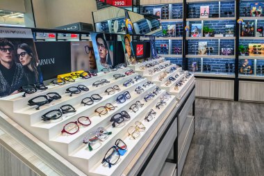 KANCHANABURI, THAILAND-OCTOBER 6, 2024 : Inside the sleek, modern optical shop offers professional eye exams and wide selection of beautiful, fashion glasses on shelves at Top Charoen Optical.