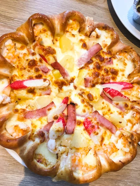 junk food is pizza with cheese, ham Crab sticks and shrimp.pizza with Pineapple, Ham Slice, Crab Sticks, Mozzarella Cheese, Thousand Island Sauce.