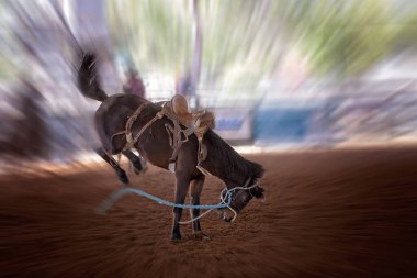 Hareket bulanıklığı ile kapalı ülke Rodeo binicisiz bucking bronco at