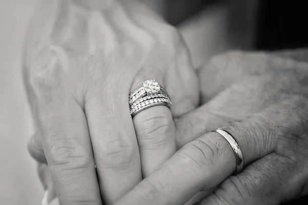 Close up of rings on bride and groom\'s hands after just being married