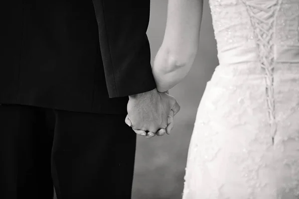Husband And Wife Holding Hands During Marriage Ceremony