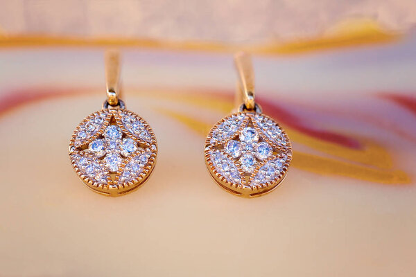 Diamond and gold earrings in an intricate and romantic modern design