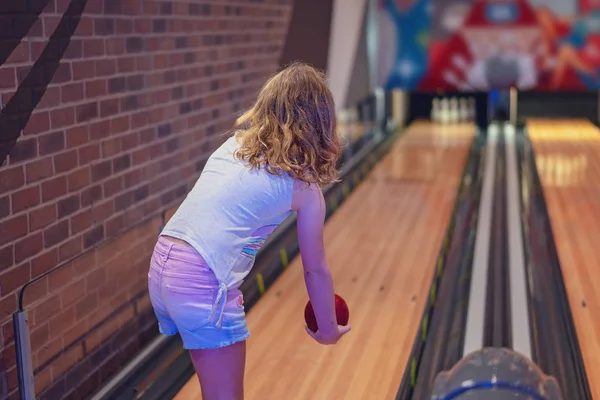 stock image Young blond haired girl wearing shorts playing a game of indoor ten pin bowls