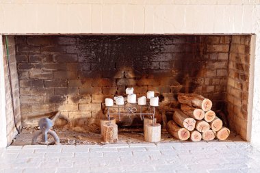 Candles And Logs In A Fireplace clipart