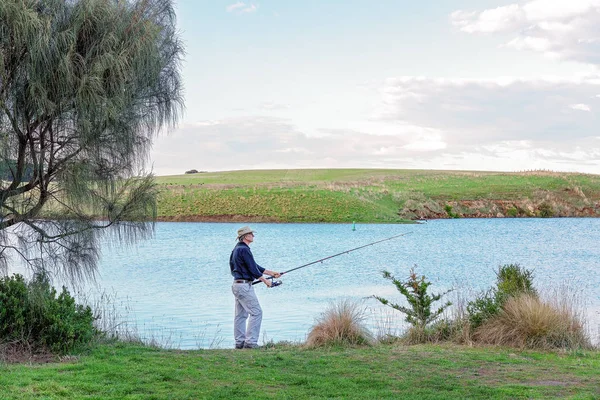 Male Retiree Fishing On A River