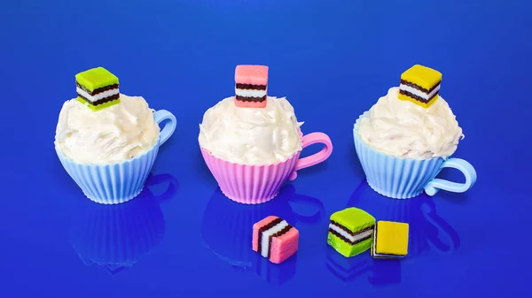 Cupcakes ozdobione cukierki na niebieskim tle — Zdjęcie stockowe
