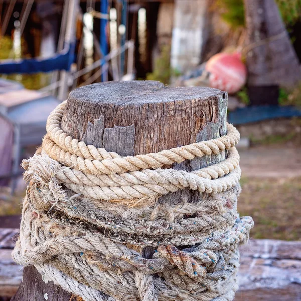 Old Timber Post Wrapped In Fraying Rope
