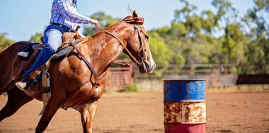 Horse And Rider Competing In Barrel Race At Outback Country Rodeo clipart