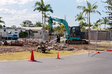 Excavator Removing An Old Bathroom At Brisbane Holiday Village clipart