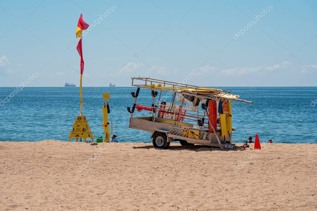 Mackay, Queensland, Australia - October 2019: Surf Lifesaving lifeguard equipment on a trailer in the sand at Harbour Beach on a bright summery day