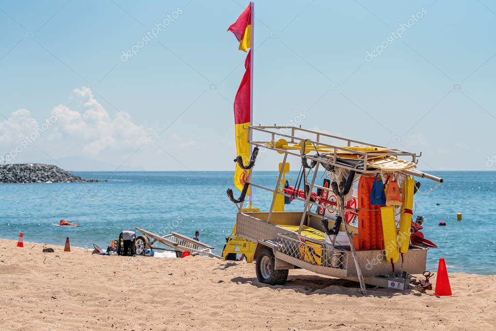 Mackay, Queensland, Australia - October 2019: Surf Lifesaving lifeguard equipment on a trailer in the sand at Harbour Beach on a bright summery day