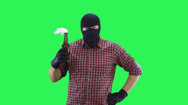 A man in a balaclava in a plaid shirt holds a Molotov cocktail in his hands. — Stock Video