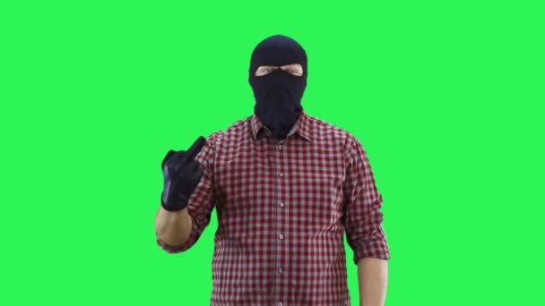 A man in a balaclava in a plaid shirt shows the middle finger with one hand. — Stock Video