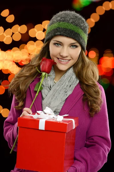 Young pretty girl with present and rose — Stock Photo, Image