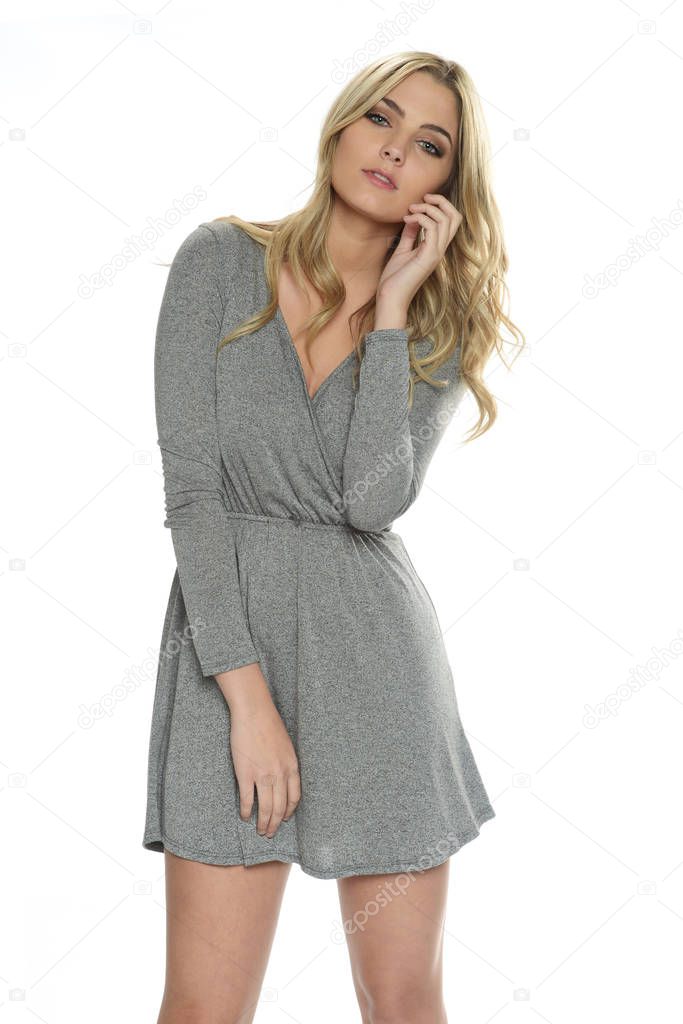 Young tenn blond woman wearing a gray dress