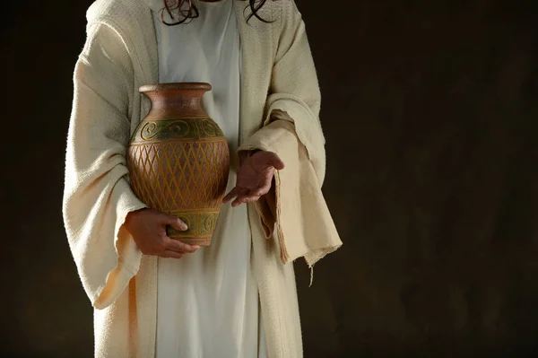 Jesus holding a jar of water standing up — Stock Photo, Image