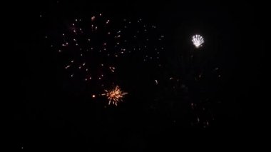 Karanlık bir arka plan aleyhine havada patlayan katlar renklerin havai fişek