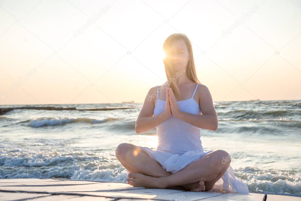serenity and yoga practicing at the sea. sunrise