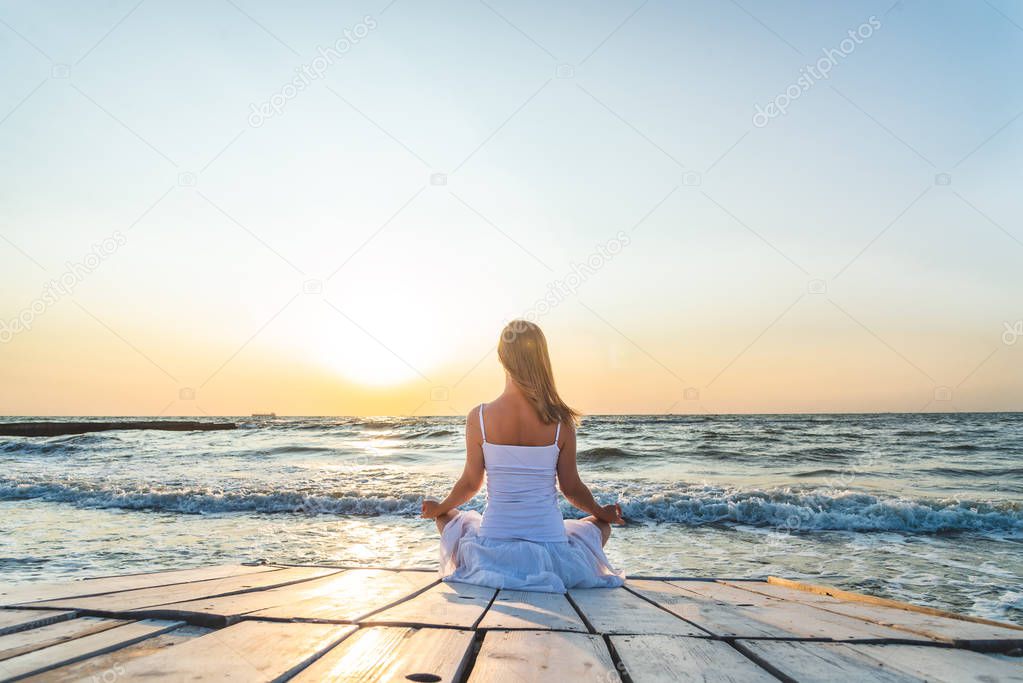 serenity and yoga practicing at the sea. sunrise