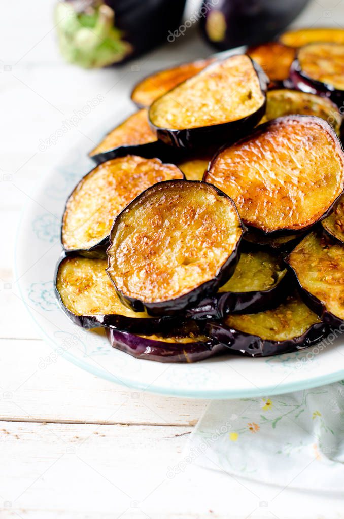 Fried eggplant on a plate on a wooden table