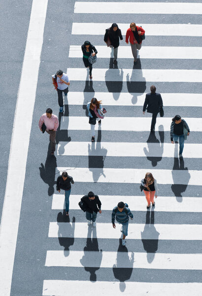 Buenos Aires, Argentina - November 13 2012: Pedestrians and traffic on the sreets of Buenos Aires city. This photo shows the downtown and de 9 de Julio Avenue arround the obelisc.