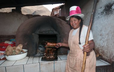 Cuzco, Peru - 13 Ağustos 2011: Perulu bir aşçı ve fırın. Kavrulmuş bir cuis gösteriliyor.