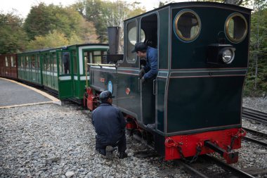Ushuaia, Arjantin - 28 Mart 2019: Lokomotifi hazırlayan tren sürücüleri turist yolculuğunu ulusal park içinde yapacaklar. Bu tren mahkûmlar tarafından 1947 yılına kadar yakacak odun taşımak için kullanıldı.