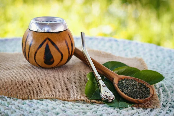 Image of Calabash with mate tea, on bright green backdrop