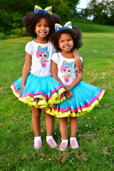 African American sisters are playing in the parkcurly African Am