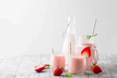 Detox diet concept: strawberry smoothie on table clipart
