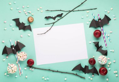 Mutlu Cadılar Bayramı konsepti. Cadılar Bayramı süslemeleri, siyah yarasalar, kağıt yeşili arkaplanda şeker. Fotokopi alanı olan Cadılar Bayramı partisi tebrik kartı modeli. Düz yatıyordu, üstten, yukarıdan..