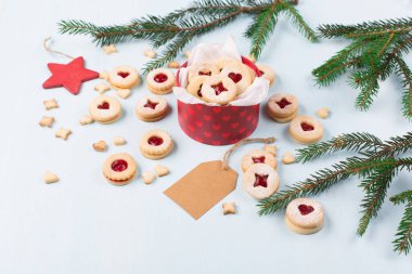 Linzer Noel ya da yeni yıl kurabiyeleri reçelle doldurulmuş ve mavi arka planda şekerle tozlanmış. Geleneksel Avusturya Noel kurabiyeleri. Kutuda ev yapımı tatlı bir hediye. DIY hediye konsepti.