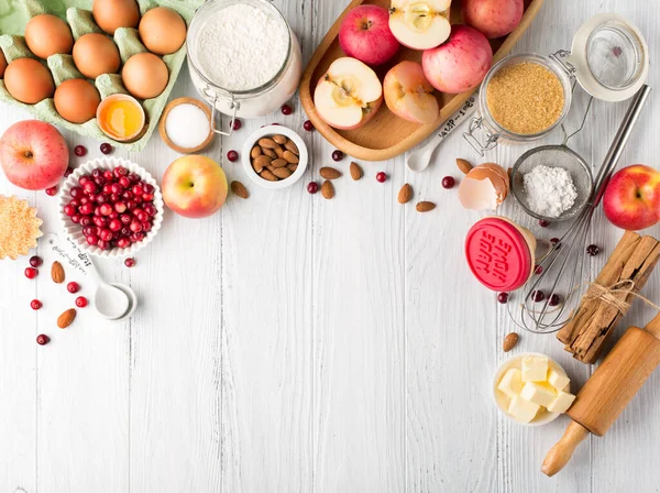 Autumn winter baking concept. Cooking baking background with ingredients, spices and utensils. Baking traditional autumn winter pie, rustic white wooden background, copy space.