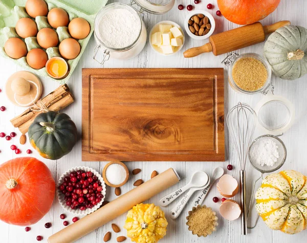 Autumn winter baking concept. Cooking baking background with ingredients, spices and utensils. Baking traditional autumn winter pie, rustic white wooden background, copy space.