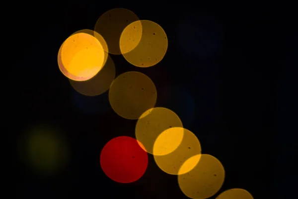 Sárga és piros kör alakú Bokeh. Sötét háttér — Stock Fotó