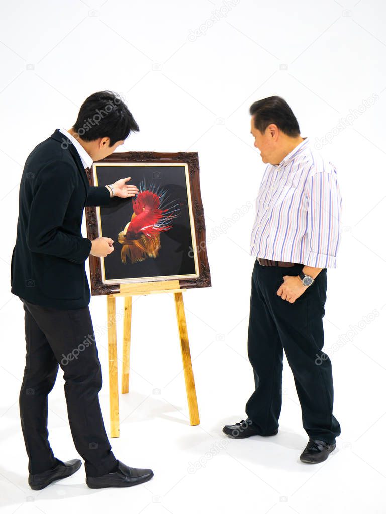 Two man talking about betta fish photo,setting on easel, in art exhibition, top view angle
