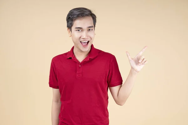 Asian young handsome and cheerful male student with hand gesture — Stock Photo, Image