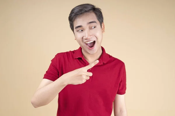 Asian young handsome and cheerful male student with hand gesture and face expression — Stock Photo, Image