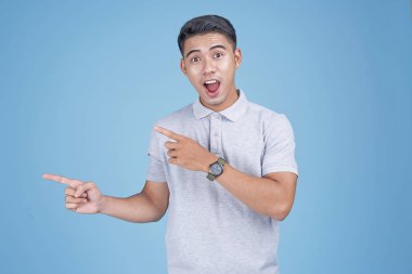 Açık mavi arka plan üzerinde el hareketi ile Asyalı genç yakışıklı adam