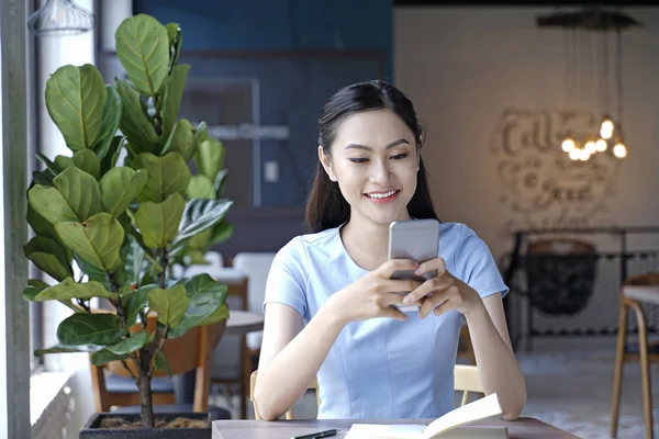 Ασίας όμορφη ελκυστική γυναίκα κάθεται σε καφετέρια χρησιμοποιώντας Smart — Φωτογραφία Αρχείου