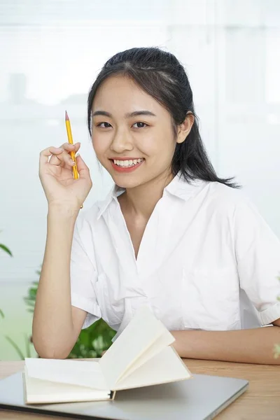 Asian cheerful pretty young teenage student in white uniform and black skirt — Stock Photo, Image