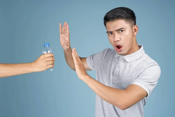 Asian young handsome attractive man with no plastic expression on blue background — Stock Photo, Image