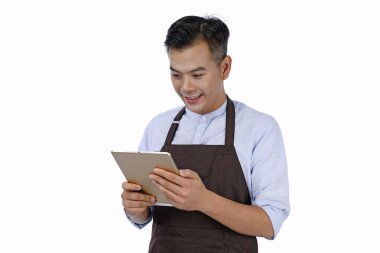 Asya yakışıklı genç garson tutan pad tablet, kahverengi renk bir