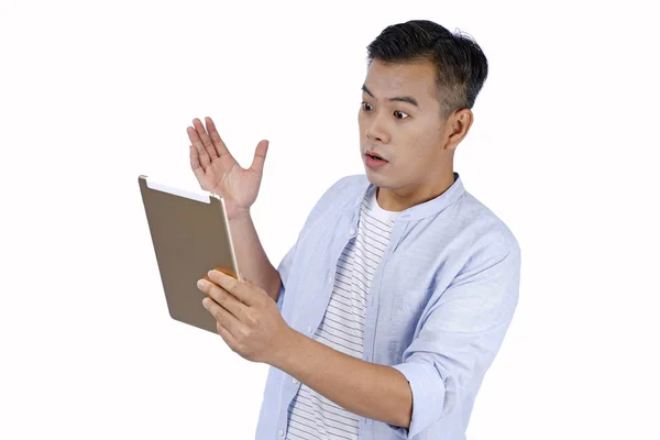 Asian handsome young man holding pad tablet with face surprise e — Stock Photo, Image