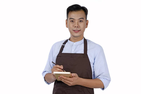 Asiatico bel giovane cameriere con grembiule marrone, isolato su — Foto Stock