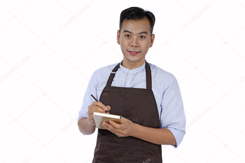 Asian handsome young waiter in brown color apron, isolated on wh
