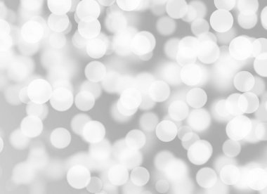 Soyut beyaz Bokeh. Gri arkaplanda bulanık daire ışığı.