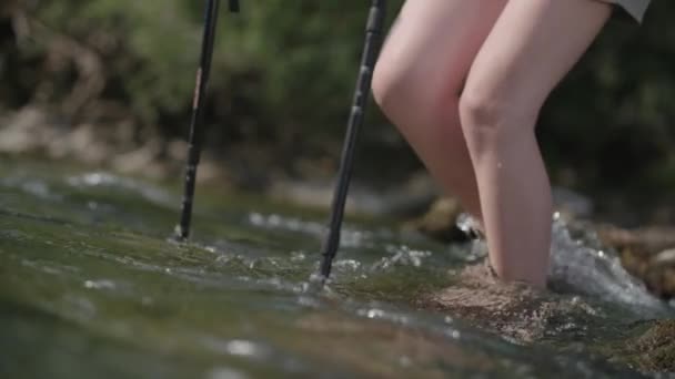 Woman Hiking Trought Strong Water Hiking Stick — Stock Video